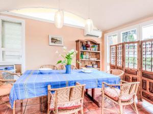 a dining room with a blue table and chairs at Villa Platja Calafato by Interhome in L'Ametlla de Mar