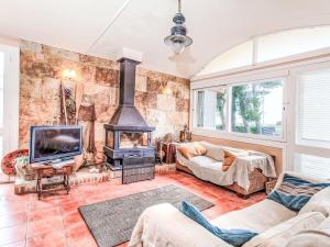 a living room with a fireplace and a tv at Villa Platja Calafato by Interhome in L'Ametlla de Mar