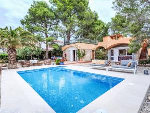 a swimming pool in the backyard of a house at Villa Platja Calafato by Interhome in L'Ametlla de Mar