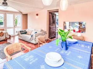 a living room with a table and a couch at Villa Platja Calafato by Interhome in L'Ametlla de Mar