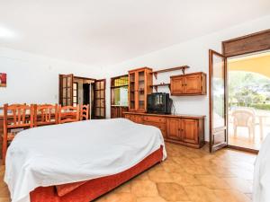 a bedroom with a large bed and a kitchen at Villa Africa by Interhome in L'Ametlla de Mar +17 photos