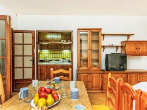 a kitchen with a wooden table with fruit on it at Villa Africa by Interhome in L'Ametlla de Mar