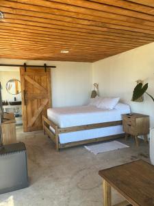 Кровать или кровати в номере Cabaña Quillay by Alto Curanipe