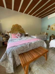 a bedroom with a large bed and a wooden bench at Apt Flat 210 Condomínio Pedra do Rodeadouro in Bonito +40 photos