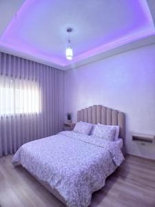 a bedroom with a large bed and a purple ceiling at Ocean Park Zenata City Eco in Casablanca +40 photos