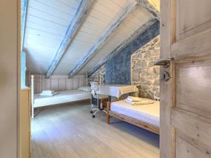 a room with two beds and a wooden door at Holiday Home Vista 2 by Interhome in Vrsar +20 photos