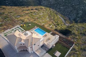 an overhead view of a house with a swimming pool at Karousa Villa - A luxury retreat with stunning views, by Zantewize in Anafonítria +37 photos