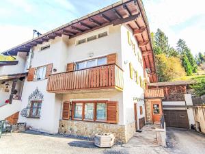 a house with a balcony on top of it at Apartment Elisa by Interhome in Ronzone