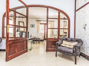 a living room with an arched door and a chair at Villa Arcada by Interhome in Miami Platja