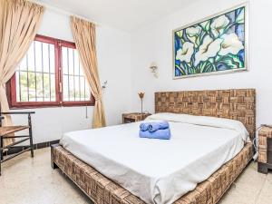 a bedroom with a bed with a blue towel on it at Villa Arcada by Interhome in Miami Platja