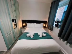 a bedroom with a large white bed with two pillows at Temple Bar apartment by DublinExchangeSuites in Dublin