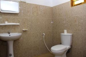 a bathroom with a toilet and a sink at Kandy Little White House in Kandy