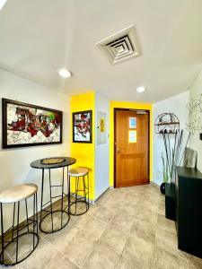 Zimmer mit zwei Barhockern und einer gelben Wand in der Unterkunft Travelers backpackers in Dubai