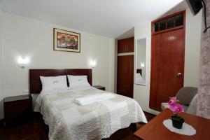 Ένα ή περισσότερα κρεβάτια σε δωμάτιο στο Witobi Hostal