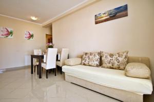 a living room with a couch and a table at Apartments Ivanka C. in Soline