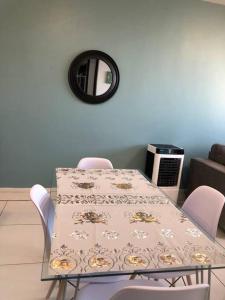 a dining room table with chairs and a mirror at Serenity at 77 Independence Avenue, Windhoek CBD in Windhoek