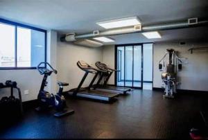 a gym with treadmills and machines in a room at Serenity at 77 Independence Avenue, Windhoek CBD in Windhoek
