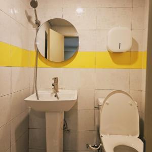 a bathroom with a sink and a toilet and a mirror at Stay Aall Seoul Train Station 2 in Seoul