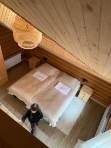 a woman standing next to a bed in a room at Voronins Retreat House in Lumshory