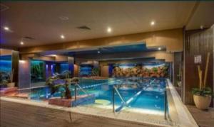 a large swimming pool in a building at FLH - 777 Apartments in Bucharest