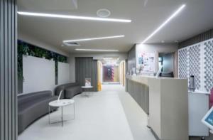 a lobby with a couch and a table and chairs at FLH - 777 Apartments in Bucharest