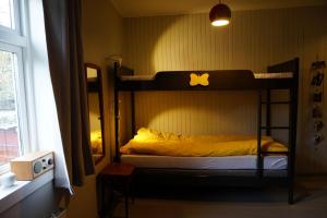 a bedroom with two bunk beds and a window at Koselig hus ved Kabelvågmarken in Kabelvåg