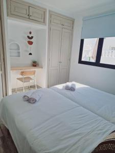 a bedroom with two beds with towels on them at Villa Mirakai in Playa Honda +32 photos