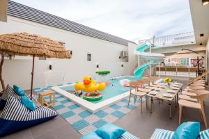 a indoor pool with a slide and a water park at Cloud9 Pool Villa in Cha Am