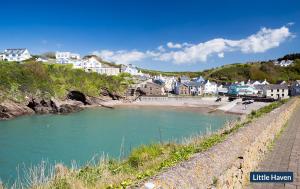a town with a beach and a river with houses at Willowcot Cottage in Haverfordwest