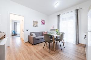 a living room with a table and a couch at Essenza Moderna - Zona Ospedale Civile in Brescia +15 photos