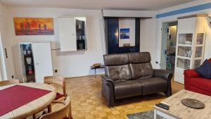 a living room with a couch and a chair and a table at Ferienwohnung Bad Neuenahr in Bad Neuenahr-Ahrweiler