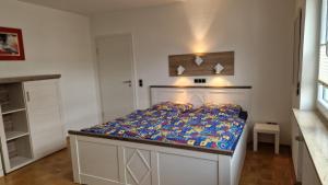 a small bedroom with a bed with a blue comforter at Ferienwohnung Bad Neuenahr in Bad Neuenahr-Ahrweiler