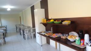 a kitchen with a counter with some food on it at Hotel Solar De Itaborai in Itaboraí