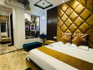 a bedroom with a large bed with a large headboard at HolidayVilla - 1st Japanese Pod, Rooms & Suites - Green Avenue Amritsar in Amritsar +173 photos