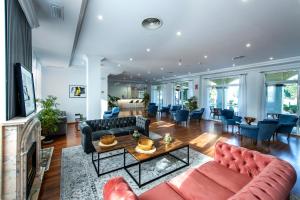 a living room with couches and a table at Hotel Tamisa Golf in Mijas