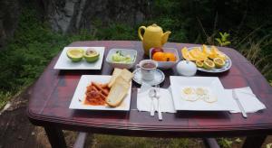 a picnic table with plates of food on it at Kandy Little White House in Kandy