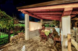 a patio with a table and chairs under awning at Il Girasole Bed and Breakfast in Donnas