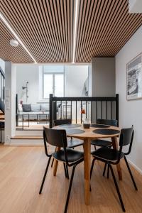 a dining room with a wooden table and chairs at Stylish Loft next to City Center & Lake Pyhäjärvi in Tampere