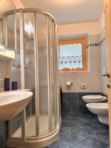 a bathroom with a shower and two toilets at Sunrise Livigno in Livigno +40 photos