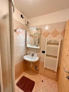 a bathroom with a sink and a mirror at Sunrise Livigno in Livigno