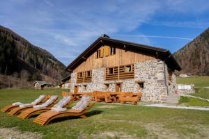 una baita con sedie a sdraio di fronte di Chalet Al Maso Val Calamento a Telve
