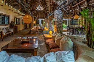 un soggiorno con un divano e un tavolo di Diani Marine Divers Village a Diani Beach