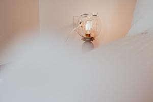 a light hanging from a wall with a candle at Appartamento Dolomiti Dream 1 in Falcade