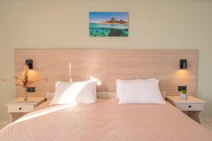 a bedroom with a large bed with two white pillows at Anthia Apartments in Marmari