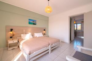 a bedroom with a large bed in a room at Anthia Apartments in Marmari