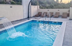 a swimming pool with a water fountain on a house at Amazing Apartment In Blato in Blato