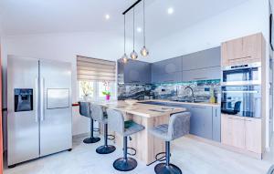 a kitchen with a wooden island with bar stools at Amazing Apartment In Blato in Blato +8 photos