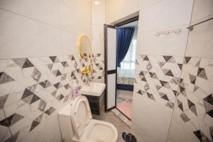 a bathroom with a toilet and a sink at MKB Homestay - Queen bed Studio Room with view & free parking in Shah Alam +10 photos