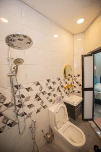 a bathroom with a toilet and a sink at MKB Homestay - Queen bed Studio Room with view & free parking in Shah Alam