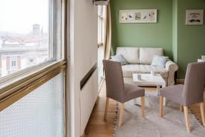a living room with a couch and a table and a window at Appartamenti Scrovegni in Padova